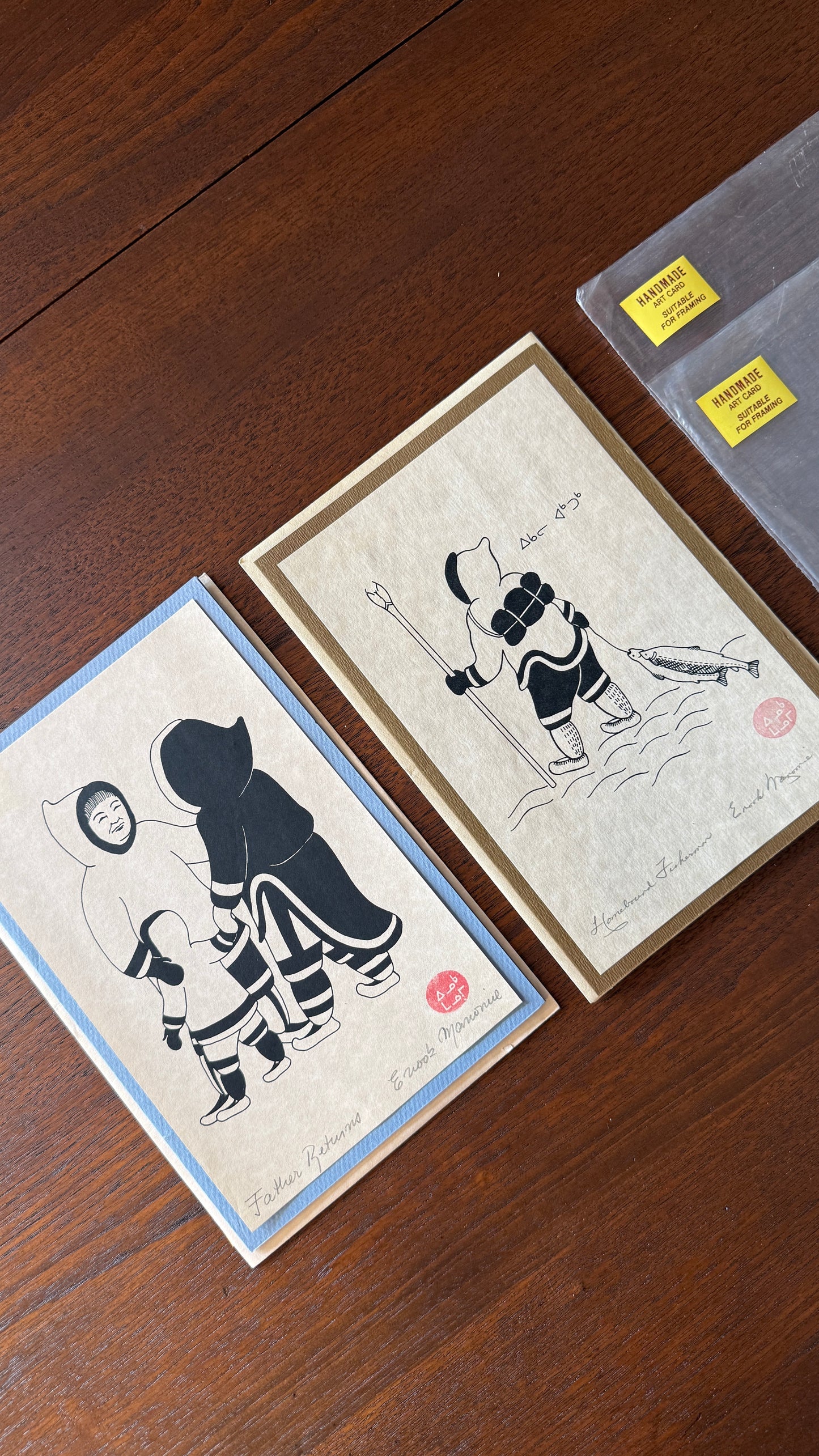 Silkscreen Prints entitled "Father Returns" and “ Homebound Fisherman”by Canadian Inuit artist Enook Manomie